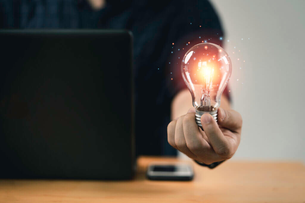 business man holding a lightbulb